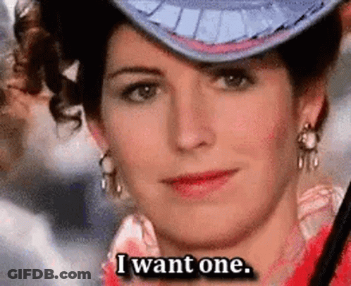 A Woman Wearing A Hat And Earrings Is Saying I Want One . GIF