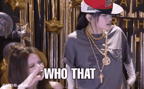 A Woman Wearing A Hat And Gold Chains Says Who That GIF