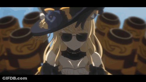 A Woman Wearing A Hat And Sunglasses Is Standing In Front Of A Bunch Of Barrels GIF