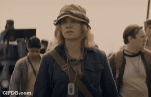 A Woman Wearing A Hat Has A Tag Around Her Neck That Says ' A ' On It GIF