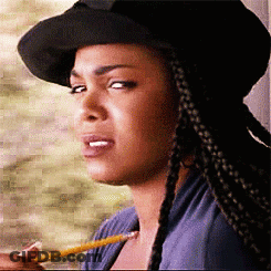 A Woman Wearing A Hat Is Holding A Pencil In Her Mouth GIF