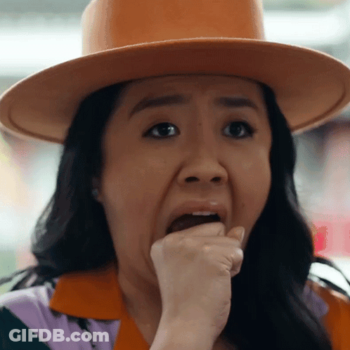 A Woman Wearing A Hat Is Making A Funny Face GIF