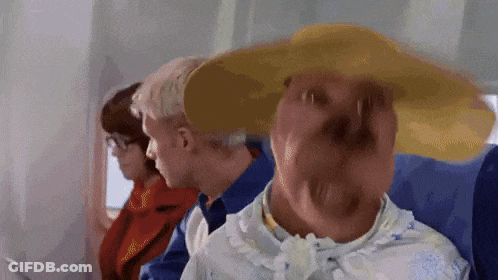 A Woman Wearing A Hat Is Sitting On A Plane GIF