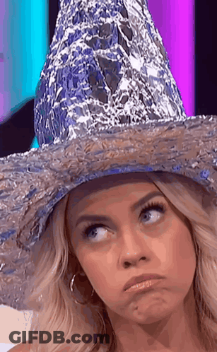 A Woman Wearing A Hat Made Out Of Tin Foil GIF