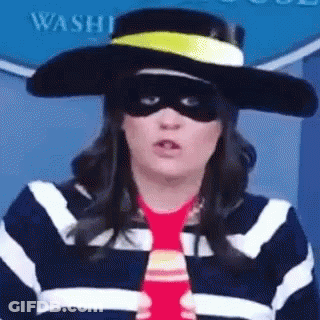 A Woman Wearing A Hat , Mask , And Tie . GIF