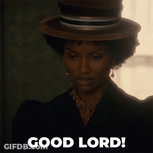 A Woman Wearing A Hat Says Good Lord On The Bottom GIF