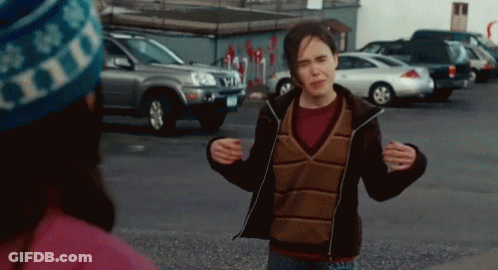 A Woman Wearing A Hat That Says Hills Is Standing In A Parking Lot GIF