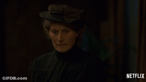 A Woman Wearing A Hat With A Netflix Logo On The Bottom GIF