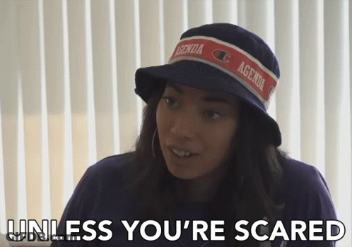A Woman Wearing A Hat With Agenda On It GIF