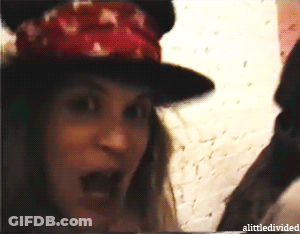 A Woman Wearing A Hat With The Word Alittle Divided On The Bottom Left GIF