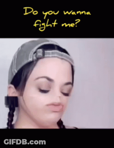 A Woman Wearing A Hat With The Words Do You Wanna Fight Me Written Above Her GIF