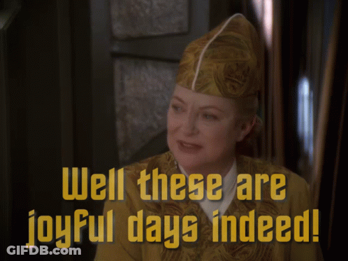 A Woman Wearing A Hat With The Words Well These Are Joyful Days Indeed GIF