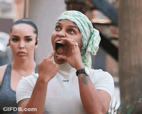 A Woman Wearing A Head Scarf And A White Shirt That Says Off GIF