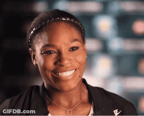 A Woman Wearing A Headband And A Necklace With The Letter E On It GIF