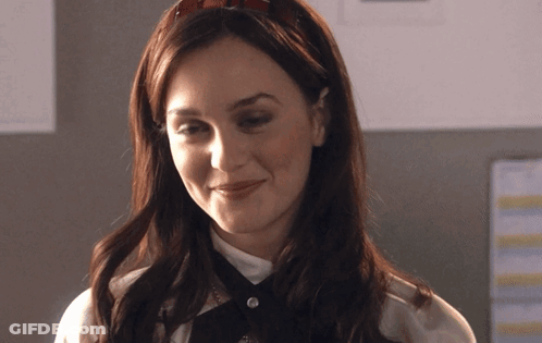 A Woman Wearing A Headband And A White Shirt Smiles GIF