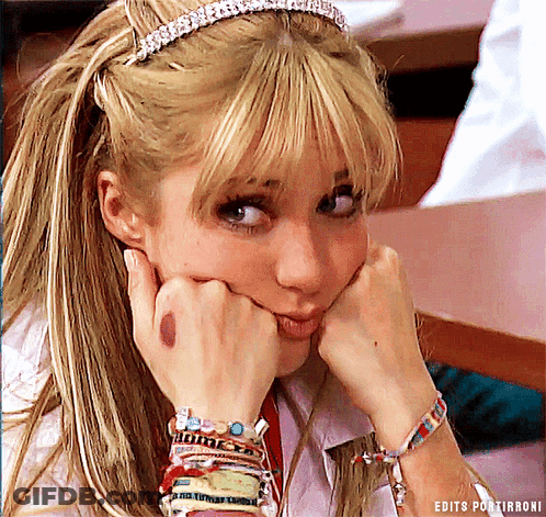 A Woman Wearing A Headband And Bracelets Has Her Hands On Her Face GIF