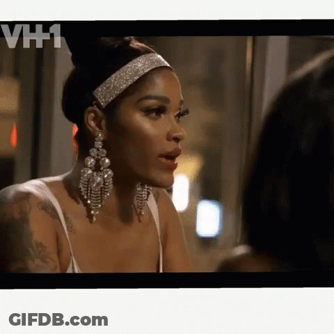 A Woman Wearing A Headband And Earrings Is Talking To Another Woman On A Tv Screen With Vh1 Written On The Bottom GIF