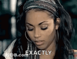 A Woman Wearing A Headband And Hoop Earrings Is Making A Face And Saying `` Exactly '' . GIF