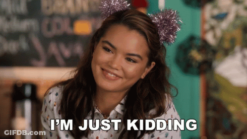 A Woman Wearing A Headband That Says ' I 'M Just Kidding ' GIF