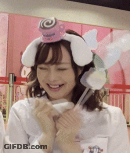 A Woman Wearing A Headband With Bunny Ears And A Lollipop On Top GIF