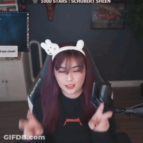 A Woman Wearing A Headband With Bunny Ears Is Giving A Peace Sign In Front Of A Screen That Says 1000 Stars GIF