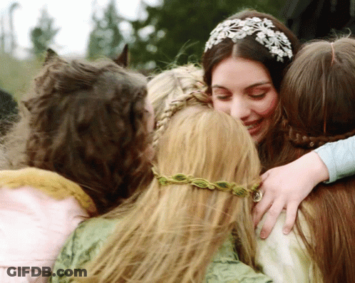 A Woman Wearing A Headband With Flowers On It Is Hugging Three Other Women GIF