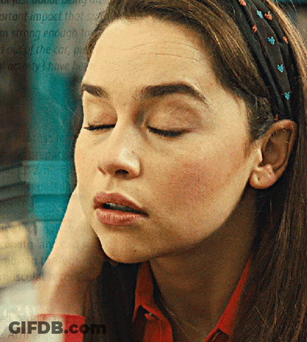 A Woman Wearing A Headband With Flowers On It GIF
