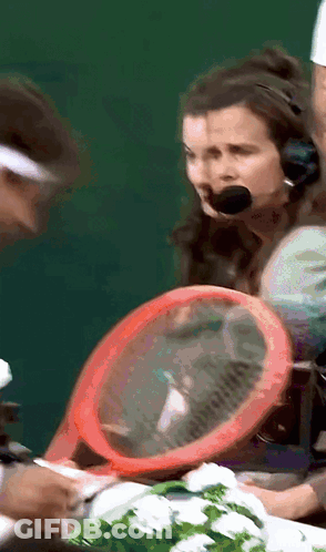 A Woman Wearing A Headset Holds A Red Racket GIF