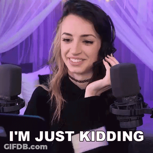 A Woman Wearing A Headset Is Smiling And Says I 'M Just Kidding . GIF
