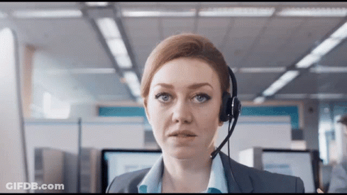 A Woman Wearing A Headset Looks At The Camera With A Serious Look On Her Face GIF