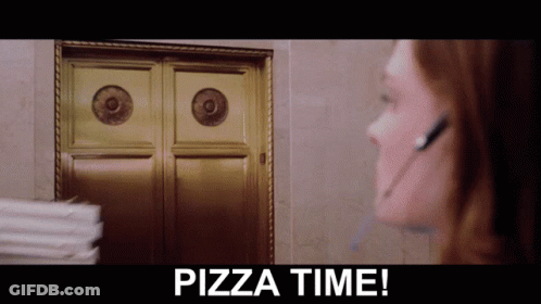 A Woman Wearing A Headset Stands In Front Of A Door With The Words Pizza Time Below Her GIF