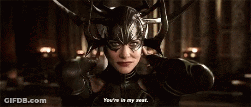 A Woman Wearing A Helmet And A Mask Is Talking To Someone . GIF