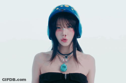 A Woman Wearing A Helmet And A Necklace With A Pendant That Says ' I Love You ' GIF