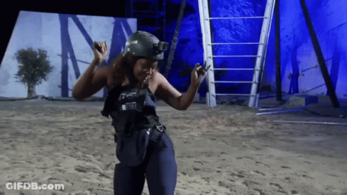 A Woman Wearing A Helmet And A Vest That Says ' Tactical ' On It GIF