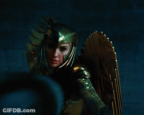 A Woman Wearing A Helmet And Gold Armor Is Holding A Sword GIF