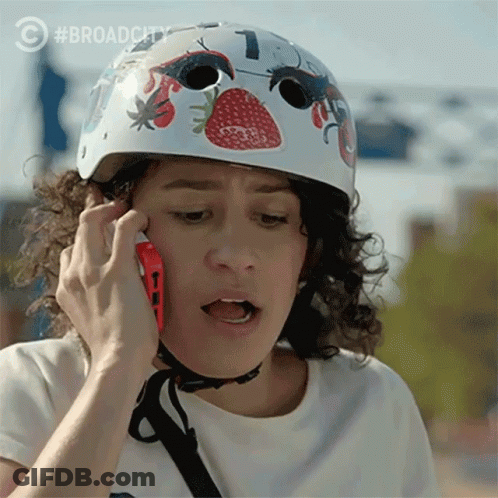 Woman With Helmet Talking On Cell Phone GIF