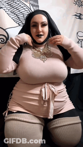 A Woman Wearing A Hijab Is Kneeling Down With Her Hands On Her Hips GIF