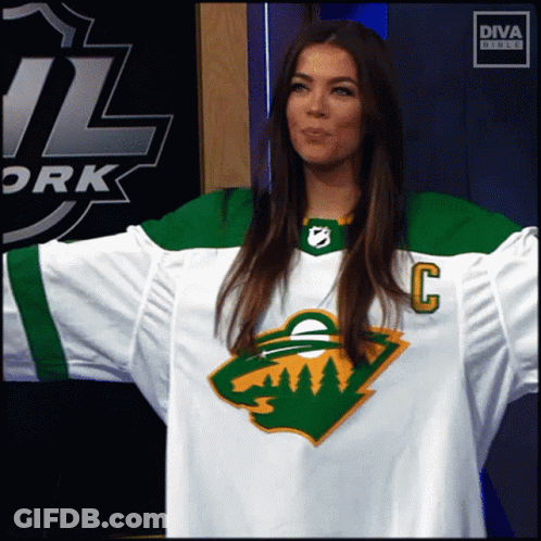A Woman Wearing A Hockey Jersey With The Letter C On The Front GIF