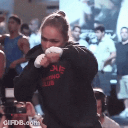A Woman Wearing A Hoodie That Says Boxing Club On It GIF