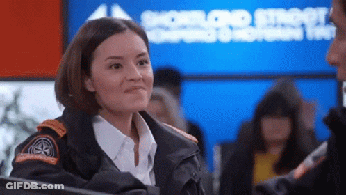A Woman Wearing A Jacket With A Patch That Says Emergency Services On It GIF
