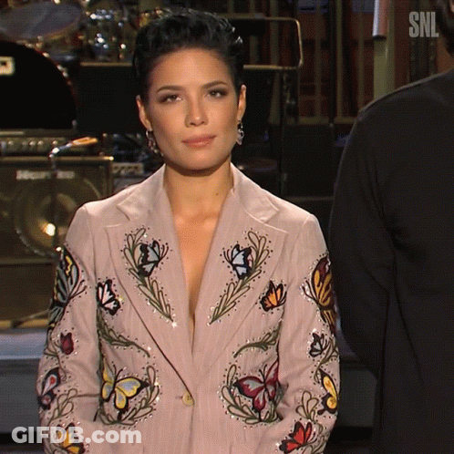 A Woman Wearing A Jacket With Butterflies And Flowers On It GIF