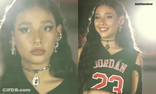 A Woman Wearing A Jordan 23 Jersey Smiles GIF