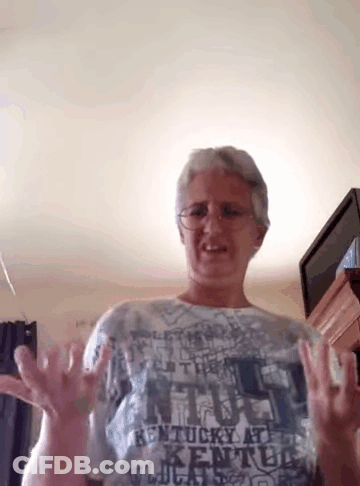 A Woman Wearing A Kentucky At Kentucky Shirt Is Making A Funny Face GIF