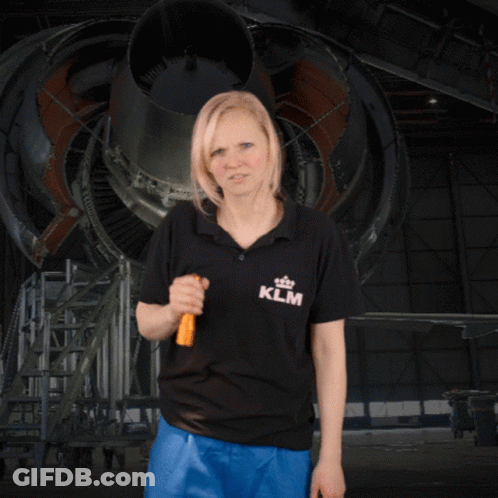 A Woman Wearing A Klm Shirt Is Holding A Flashlight GIF