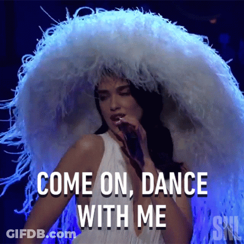 A Woman Wearing A Large White Feathered Hat Is Singing Into A Microphone And Says Come On Dance With Me GIF