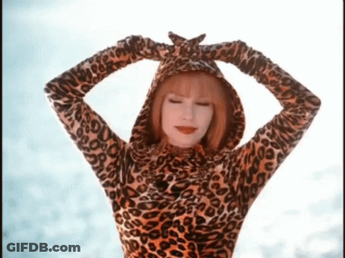 A Woman Wearing A Leopard Print Hooded Top With Her Hands On Her Head GIF