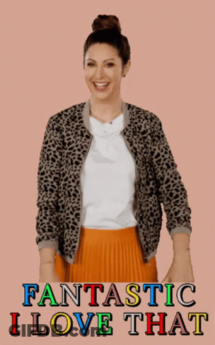 A Woman Wearing A Leopard Print Jacket And An Orange Pleated Skirt GIF