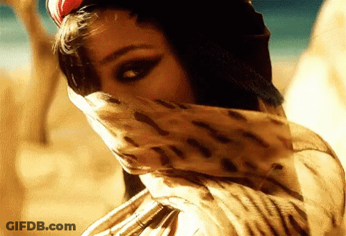 A Woman Wearing A Leopard Print Scarf Covering Her Face GIF