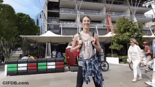 A Woman Wearing A Let 'S Set Go Tank Top GIF