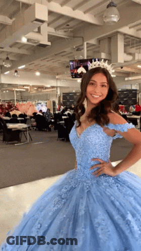 A Woman Wearing A Light Blue Ball Gown With A Tiara On Her Head GIF